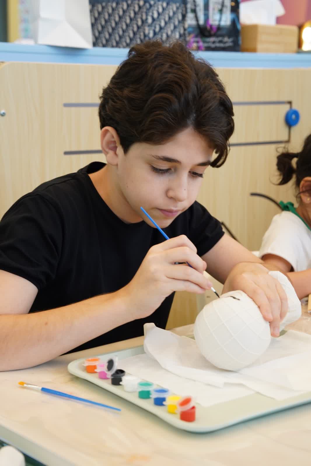 Child painting a character design