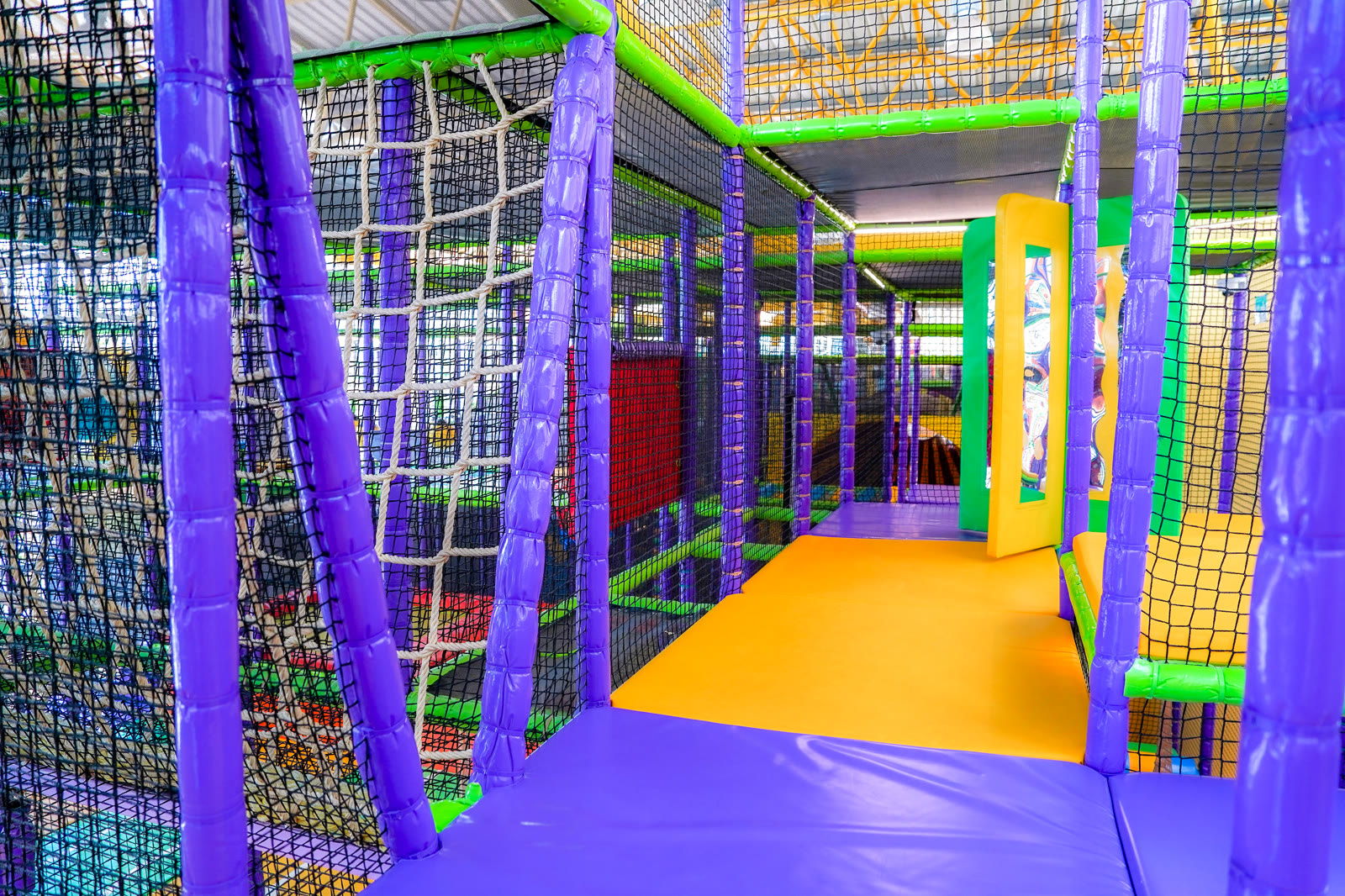 Indoor playground with trampoline and obstacle courses