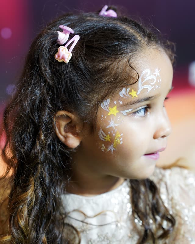 Child with festive face paint at a YOOYOO celebration